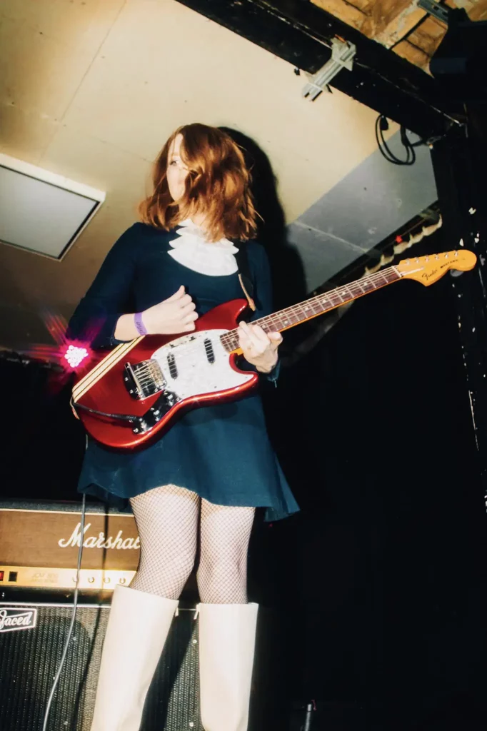 Roanne Evans from noise rock band Mums playing a Red Fender Mustang live at Society Of Losers live event in Manchester